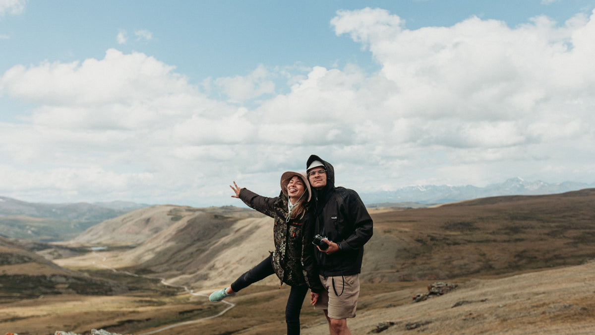 Smiling couple having fun on a mountain summit